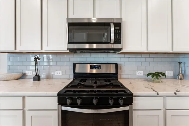 a stove top oven sitting inside of a kitchen