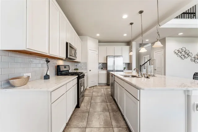 a kitchen with stainless steel appliances kitchen island granite countertop a sink and cabinets
