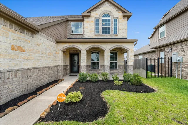 a front view of a house with garden