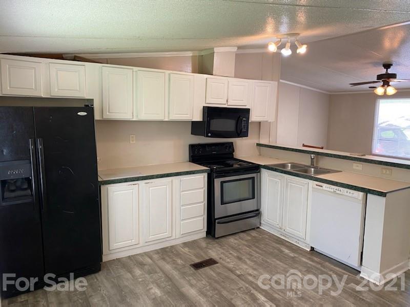 3310 Falcon Ridge Road Maiden, NC 28650 - Photo 5 of 12 a kitchen with a sink and a stove top oven