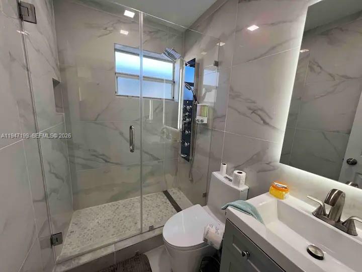 1925 Dewey Street, Unit 3 Hollywood, FL 33020 - Photo 19 of 27 a bathroom with a sink a toilet and shower