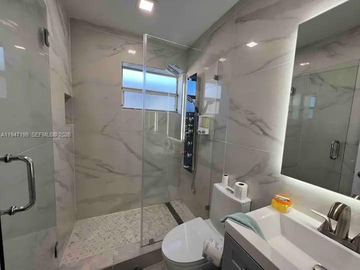 1925 Dewey Street, Unit 3 Hollywood, FL 33020 - Photo 21 of 27 a bathroom with a sink toilet and shower