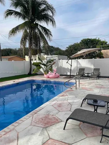 a view of a swimming pool with a yard