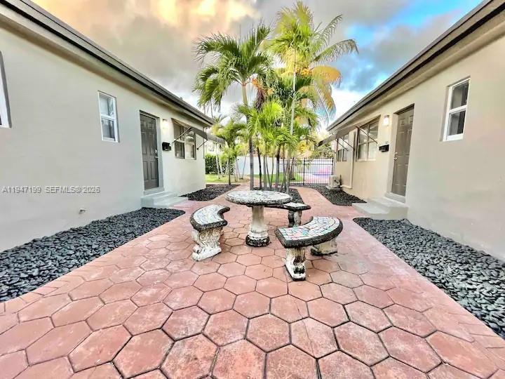 1925 Dewey Street, Unit 3 Hollywood, FL 33020 - Photo 4 of 27 a view of a patio with couple of chairs and a fountain