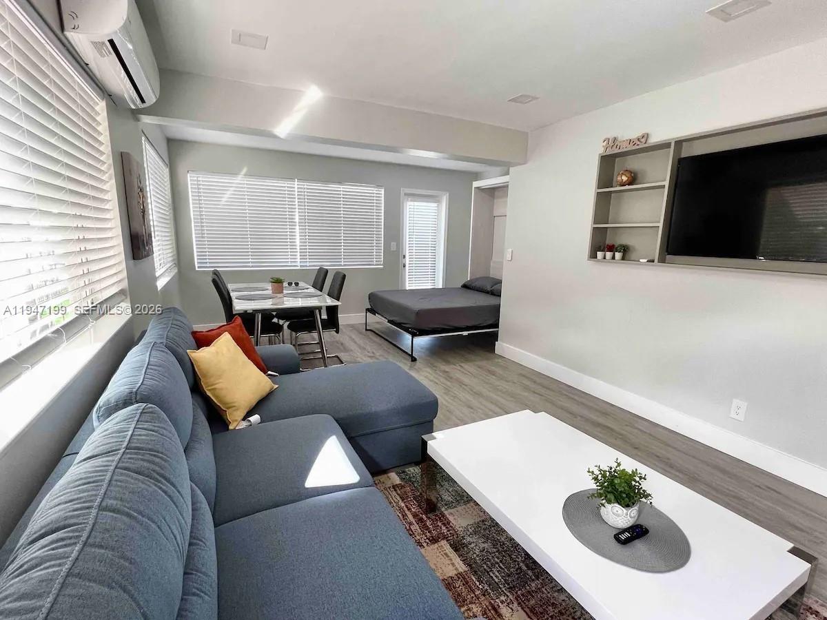 1925 Dewey Street, Unit 3 Hollywood, FL 33020 - Photo 5 of 27 a living room with furniture and a flat screen tv