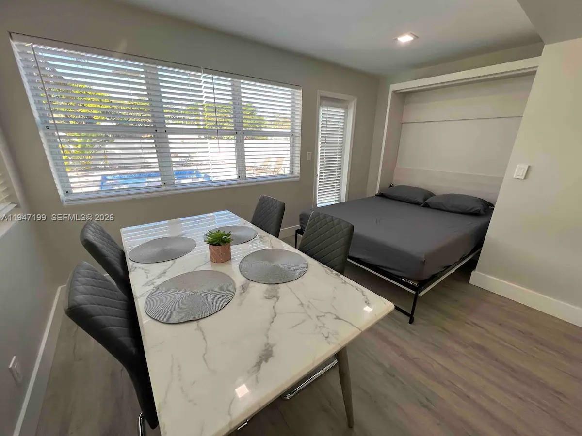 1925 Dewey Street, Unit 3 Hollywood, FL 33020 - Photo 7 of 27 a living room with furniture and a table