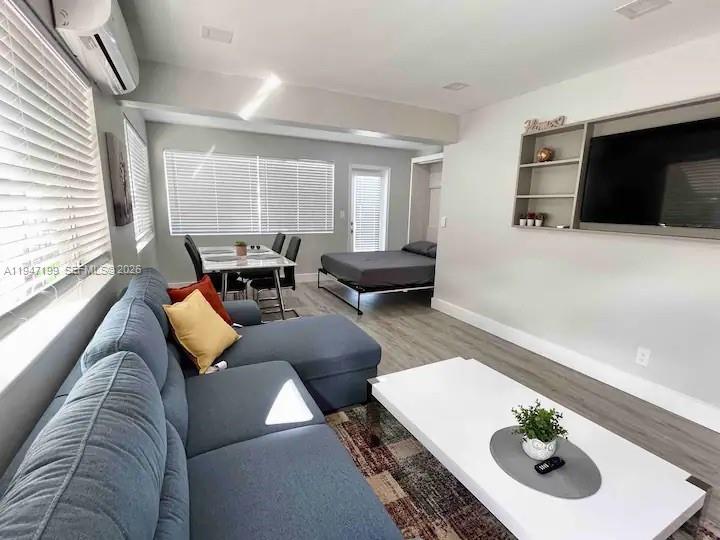 1925 Dewey Street, Unit 3 Hollywood, FL 33020 - Photo 9 of 27 a living room with furniture and a flat screen tv