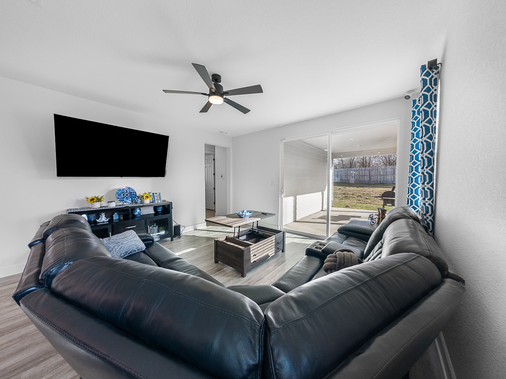 20811 Phebe Foster Street Manor, TX 78653 - Photo 14 of 40 Living room with wood finished floors and ceiling fan