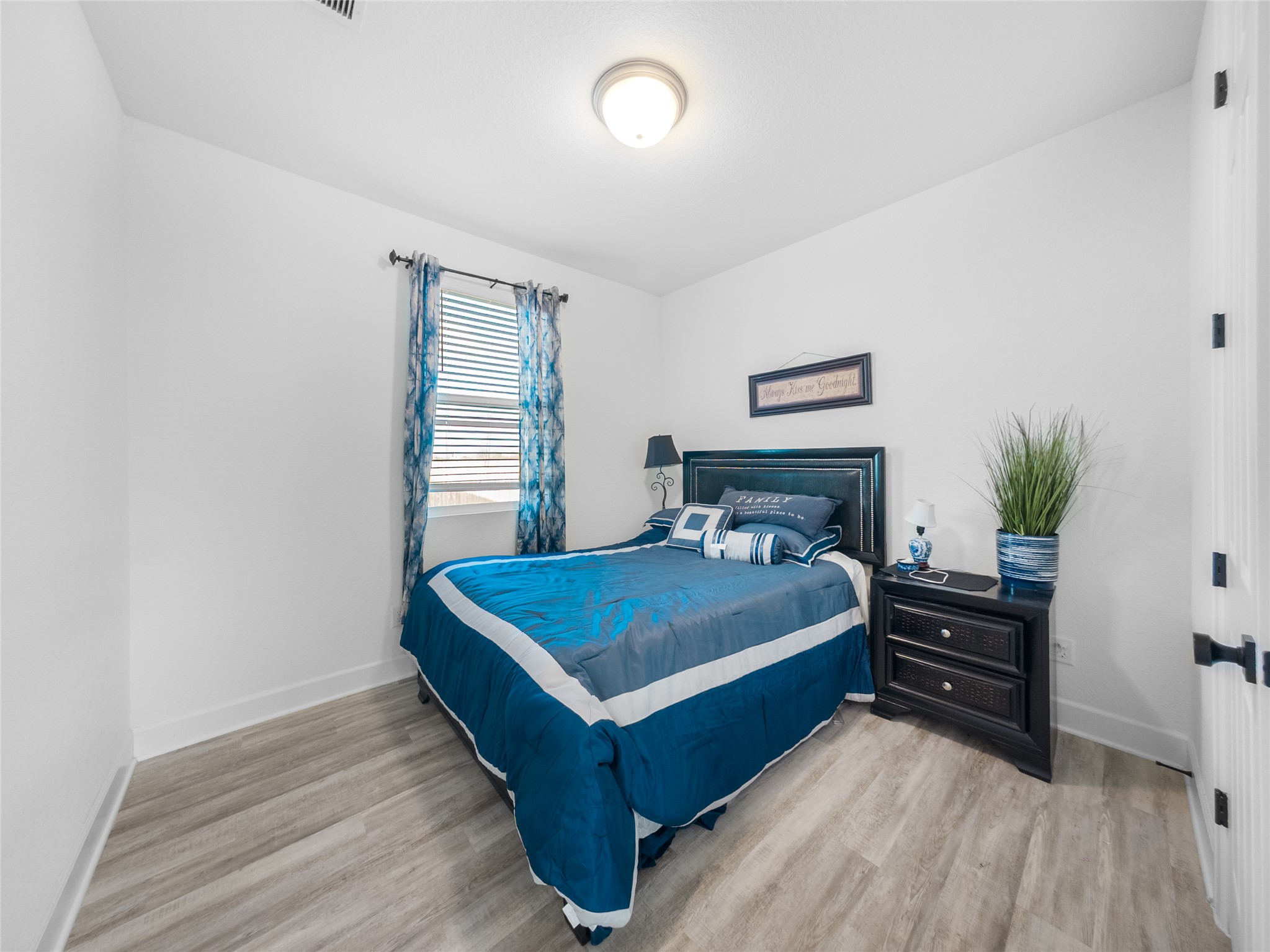 20811 Phebe Foster Street Manor, TX 78653 - Photo 22 of 40 Bedroom with light wood finished floors and baseboards