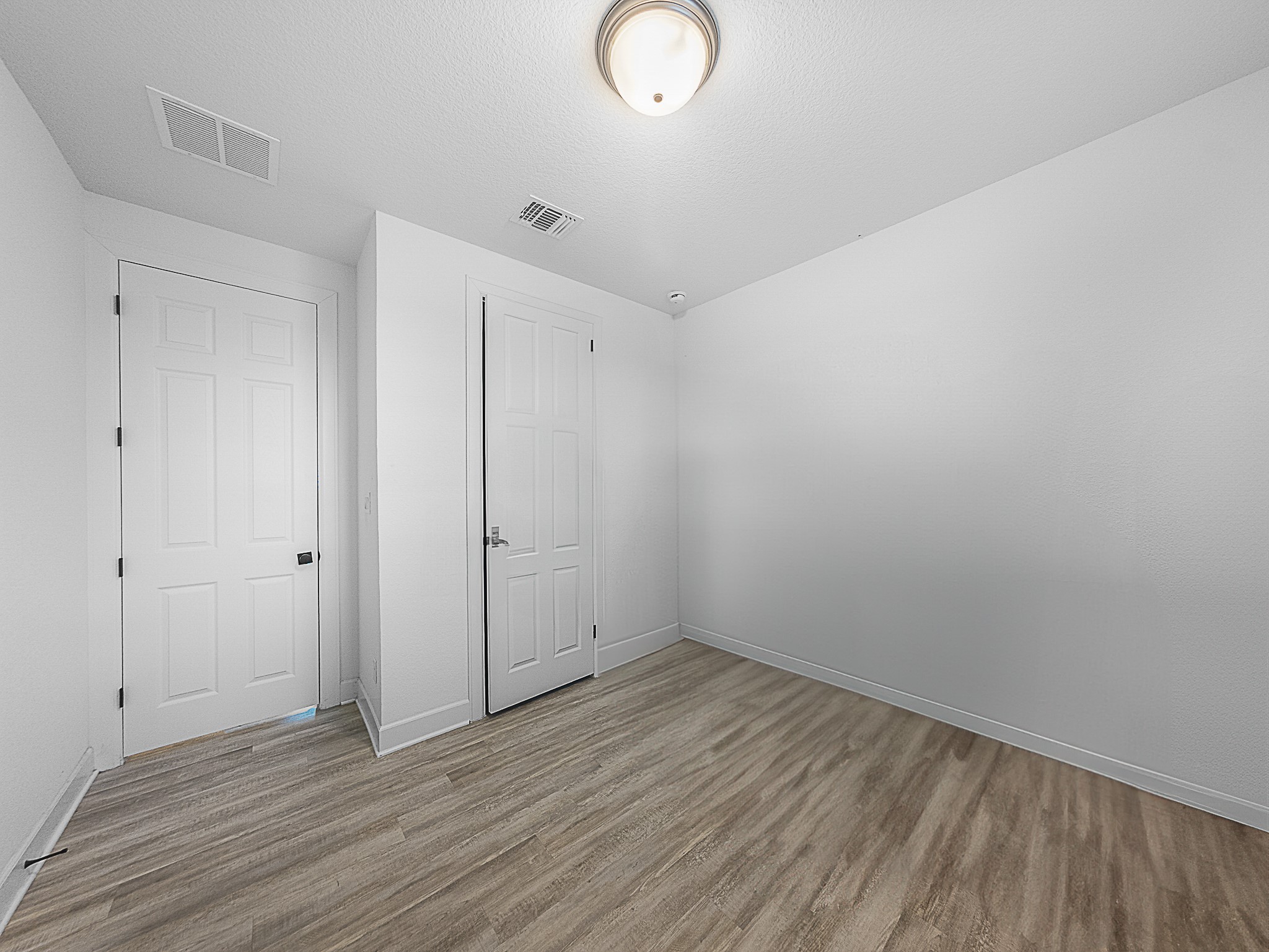 20811 Phebe Foster Street Manor, TX 78653 - Photo 23 of 40 Unfurnished bedroom with light wood-style floors, a textured ceiling, and a closet