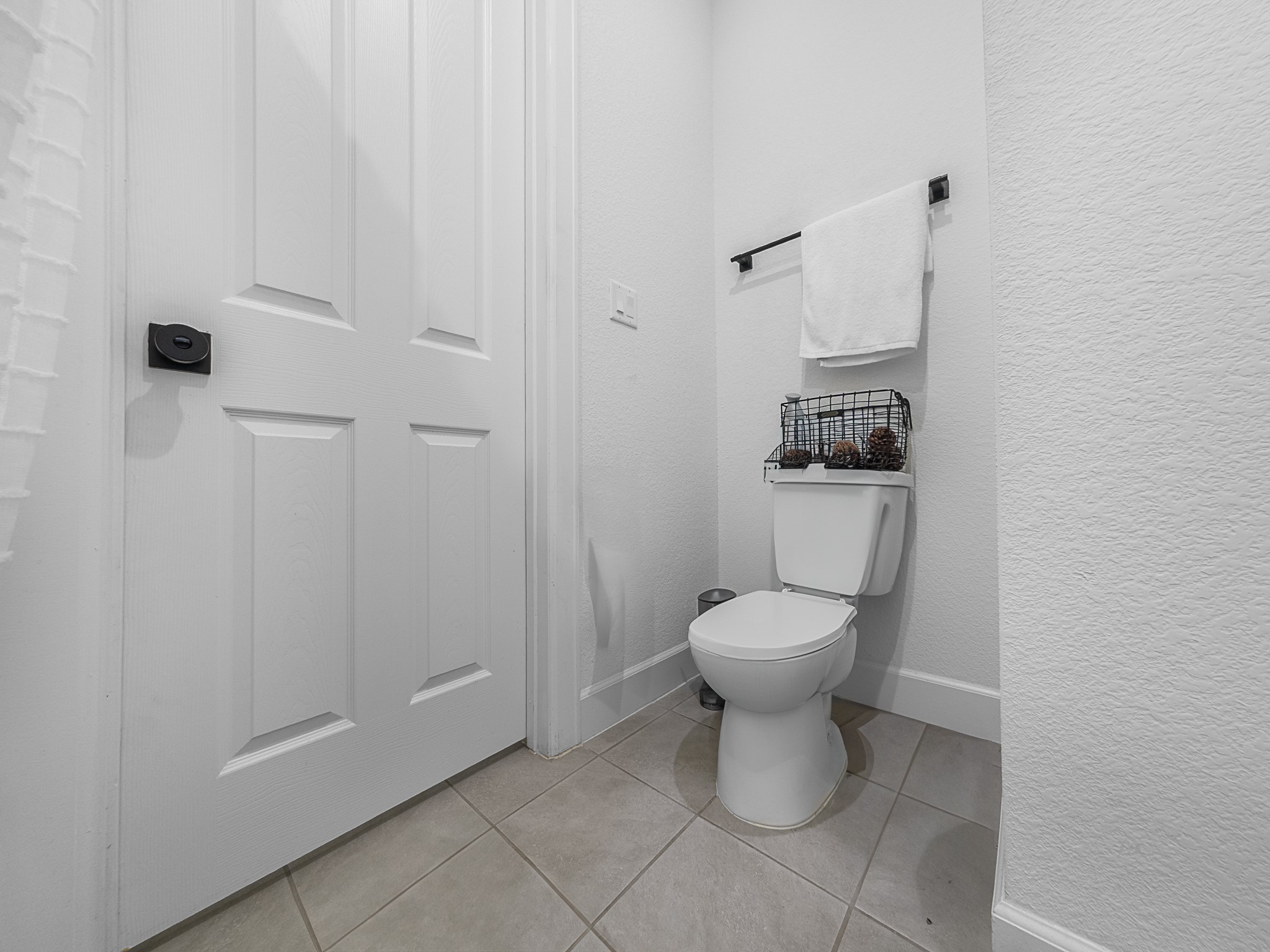 20811 Phebe Foster Street Manor, TX 78653 - Photo 27 of 40 Bathroom with a textured wall and light tile patterned flooring