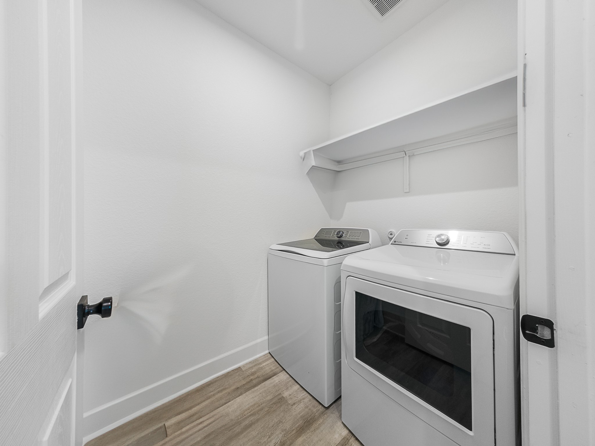 20811 Phebe Foster Street Manor, TX 78653 - Photo 28 of 40 Laundry room with light wood-style floors and separate washer and dryer