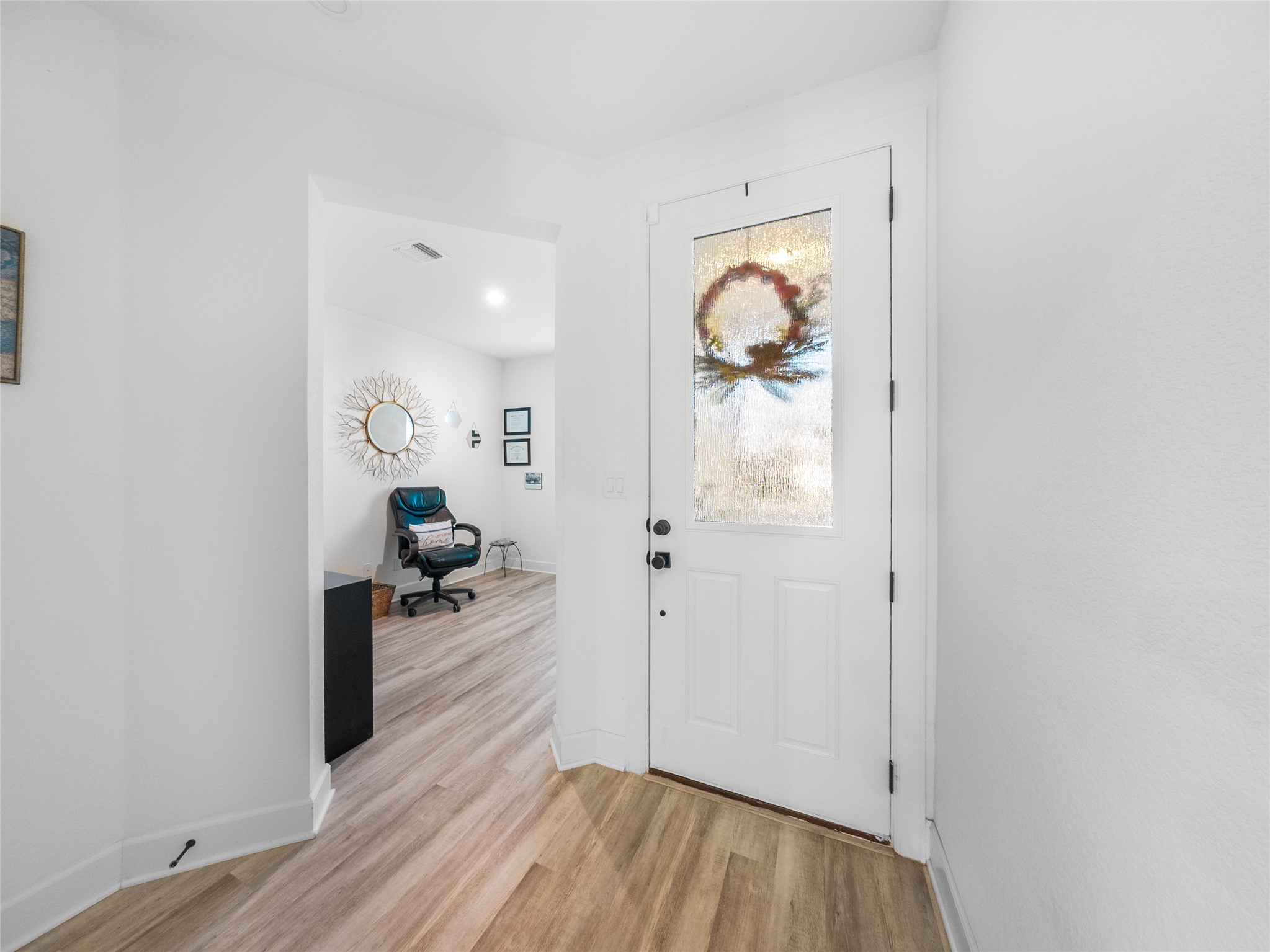 20811 Phebe Foster Street Manor, TX 78653 - Photo 5 of 40 Foyer with light wood finished floors and recessed lighting