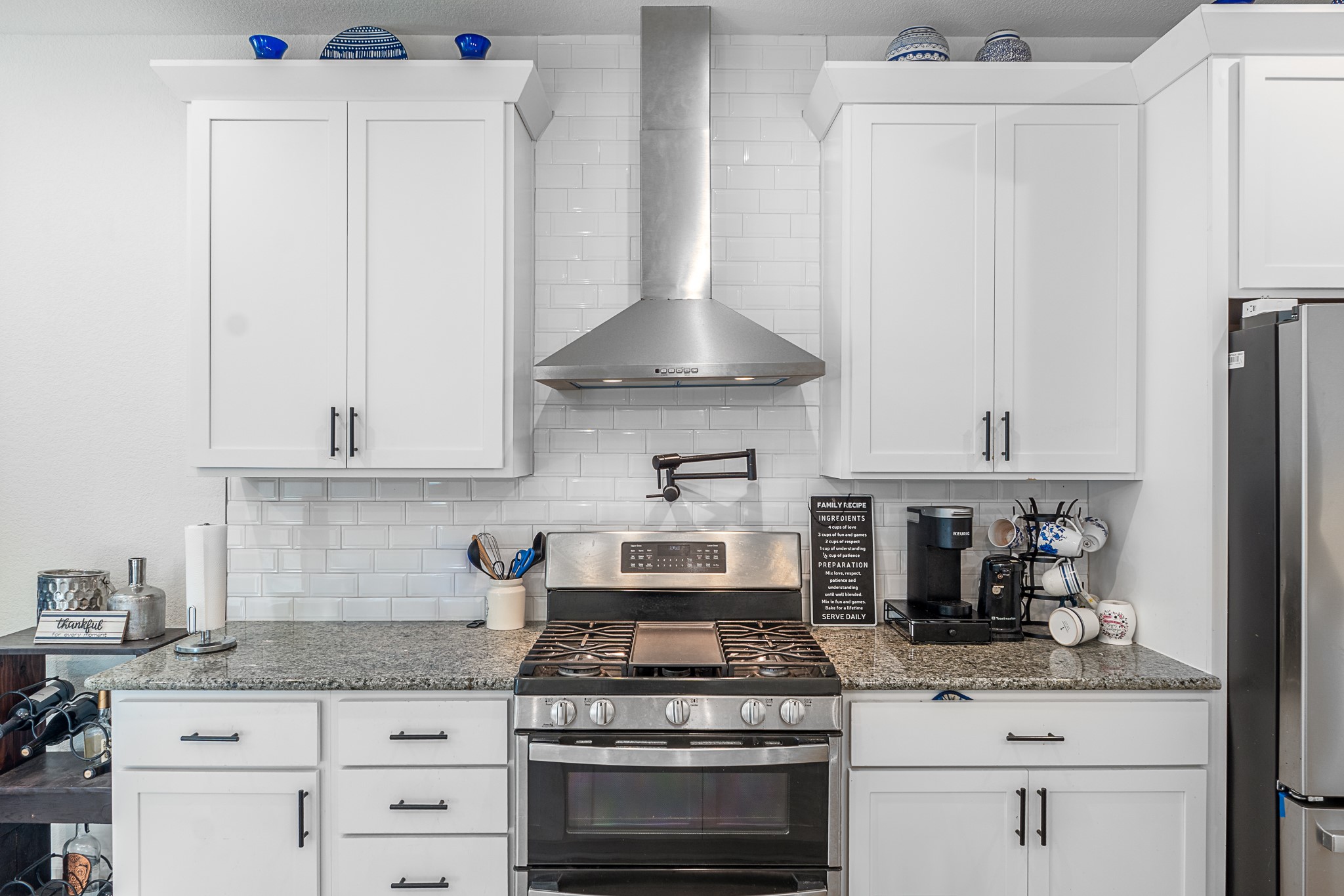 20811 Phebe Foster Street Manor, TX 78653 - Photo 7 of 40 Kitchen featuring stainless steel appliances, white cabinets, and light stone counters