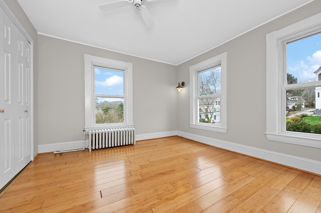 18 Bennett Street, Unit 2 Manchester, MA 01944 - Photo 13 of 21 an empty room with wooden floor and windows