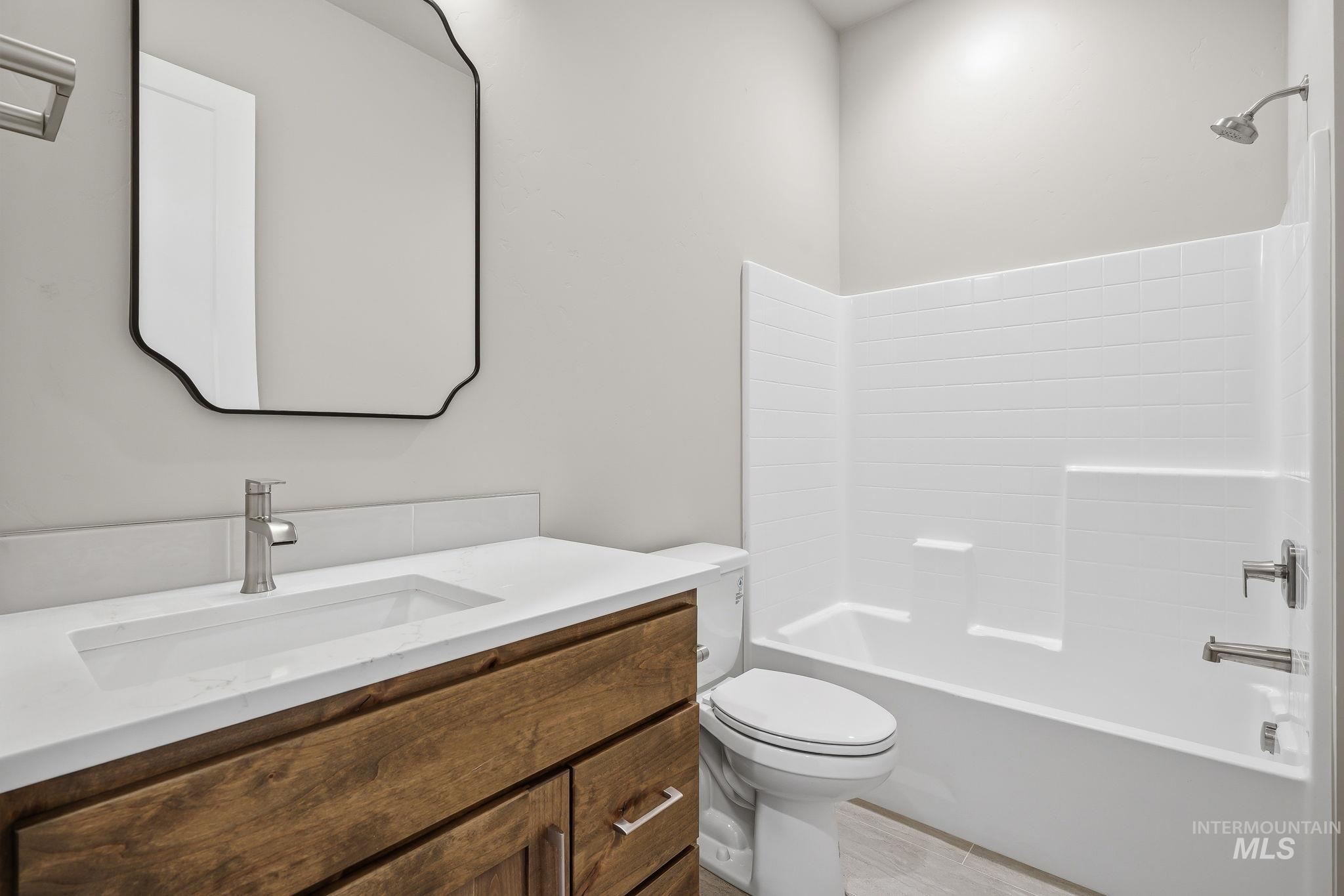 470 South Radiator Way Boise, ID 83716 - Photo 42 of 50 Bathroom featuring a wood-finish vanity with a white countertop and integrated rectangular sink