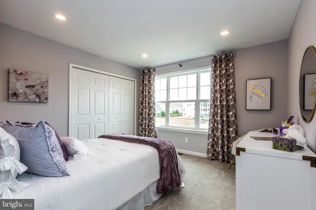 a spacious bedroom with a bed and a window