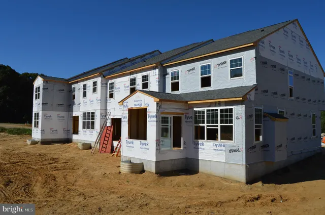 a view of a white house with large windows