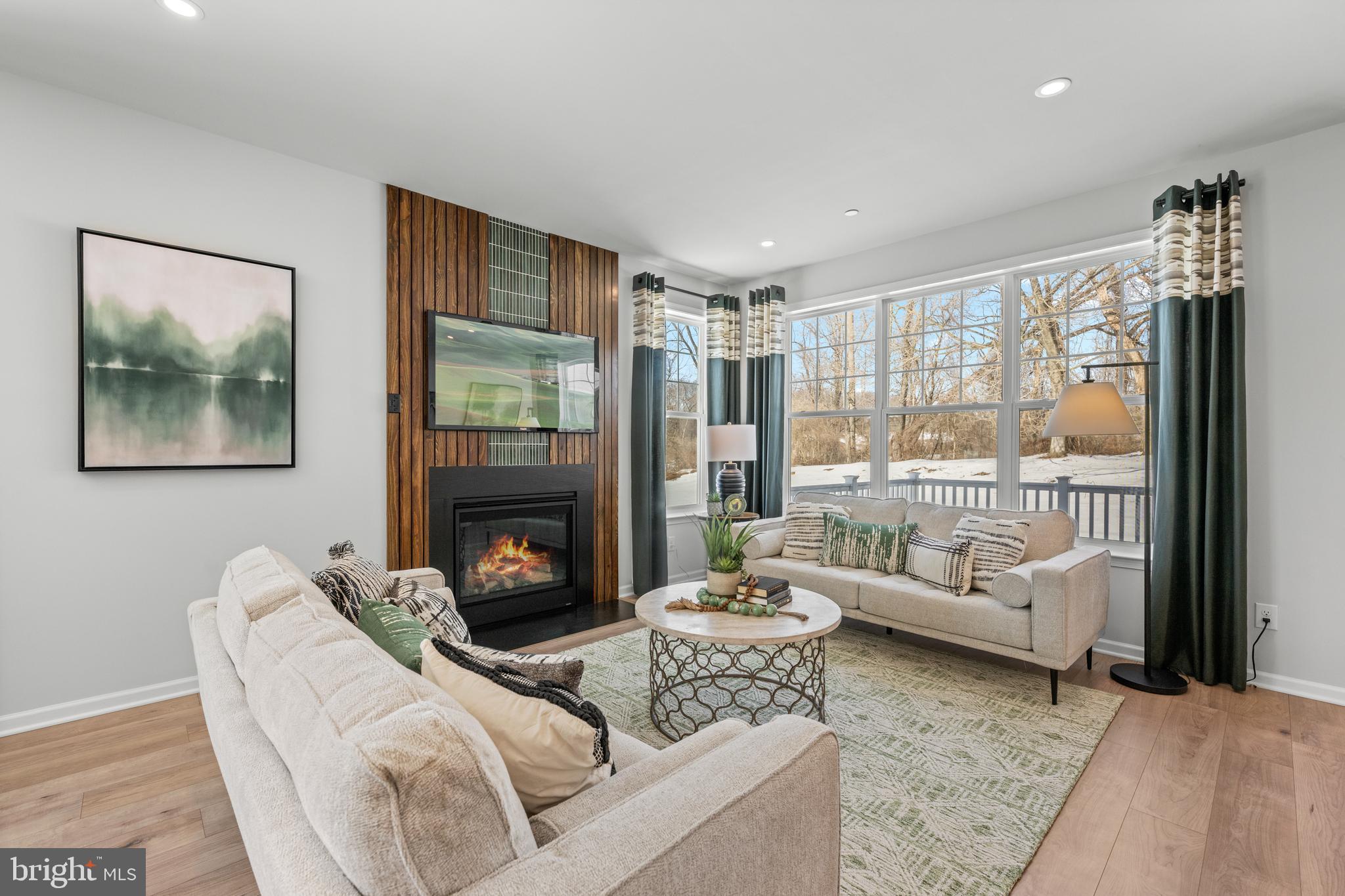 156 Bancroft Road, Unit SGR Kennett Square, PA 19348 - Photo 8 of 46 a living room with furniture a large window and a fireplace