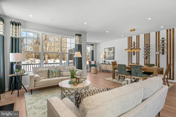 a living room with furniture and large windows