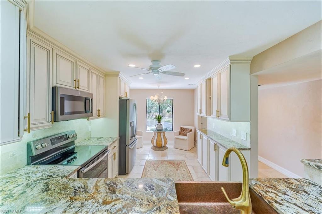 Undisclosed Address Naples, FL 34105 - Photo 12 of 24 a living room with fireplace furniture and a rug
