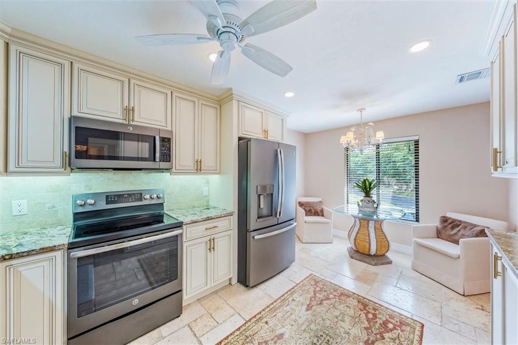 Undisclosed Address Naples, FL 34105 - Photo 13 of 24 a kitchen with stainless steel appliances granite countertop a refrigerator stove microwave and sink