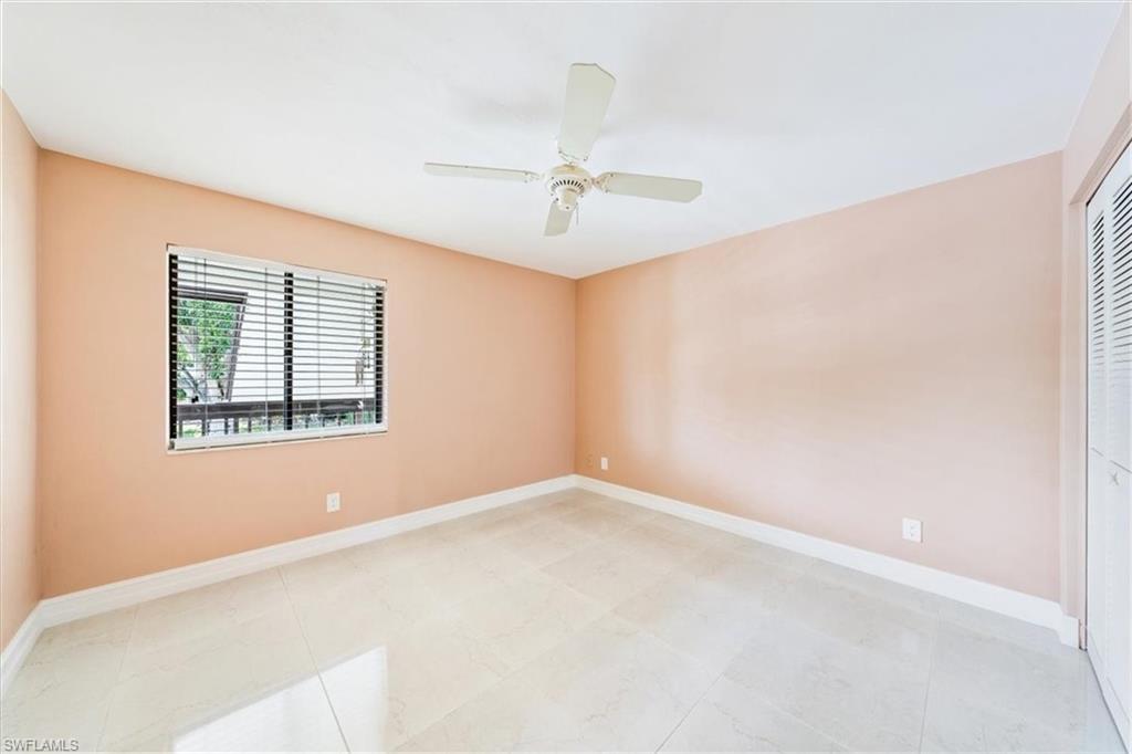 Undisclosed Address Naples, FL 34105 - Photo 14 of 24 an empty room with windows and fan
