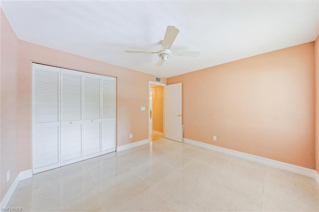 Undisclosed Address Naples, FL 34105 - Photo 15 of 24 an empty room with a ceiling fan and a window