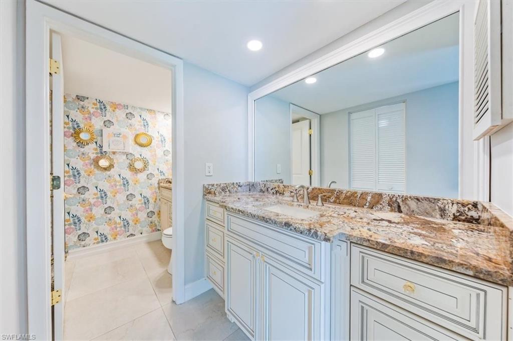 Undisclosed Address Naples, FL 34105 - Photo 20 of 24 a bathroom with a granite countertop sink and a mirror