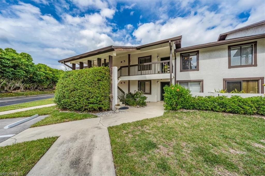 Undisclosed Address Naples, FL 34105 - Photo 2 of 24 a front view of a house with a yard