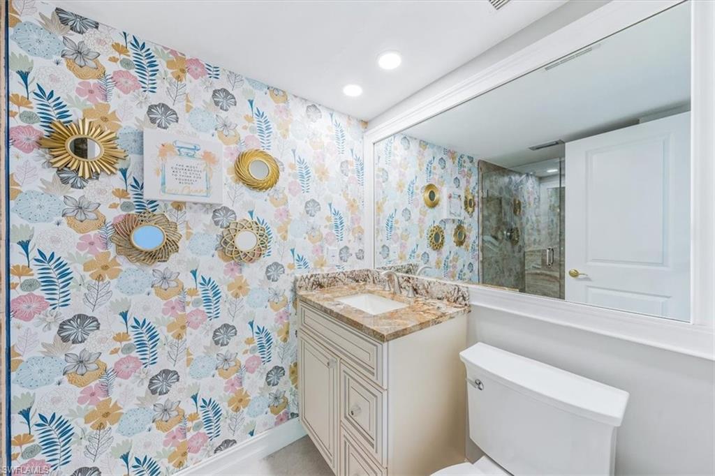 Undisclosed Address Naples, FL 34105 - Photo 21 of 24 a bathroom with a sink and mirror with toilet