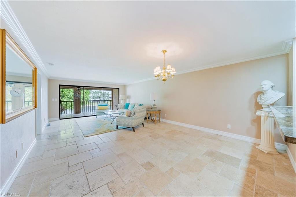 Undisclosed Address Naples, FL 34105 - Photo 8 of 24 a spacious bedroom with a bed and a large window