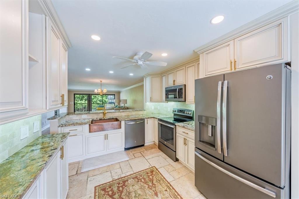 Undisclosed Address Naples, FL 34105 - Photo 10 of 24 a kitchen with stainless steel appliances granite countertop a refrigerator sink and stove