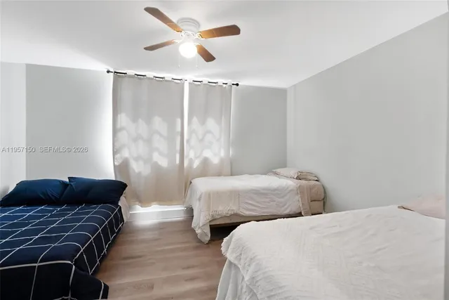 a bedroom with two beds and a chandelier