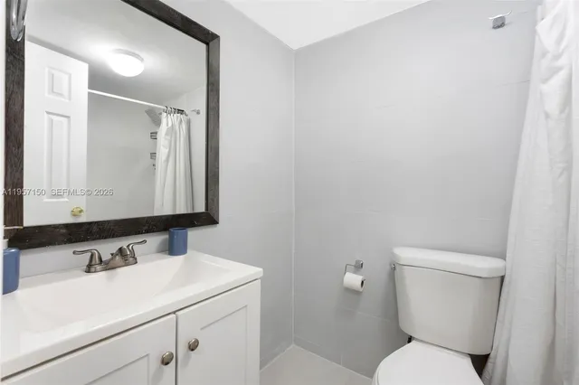 a bathroom with a sink toilet and mirror