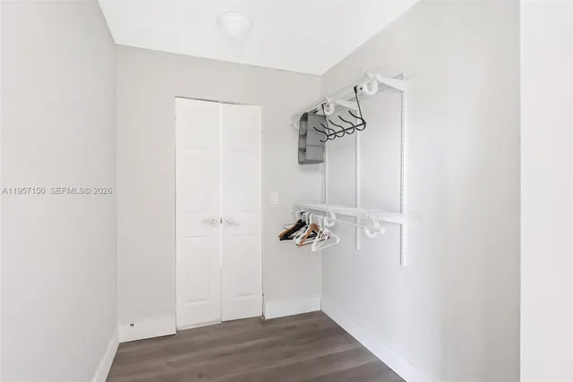 a view of a room with wooden floor