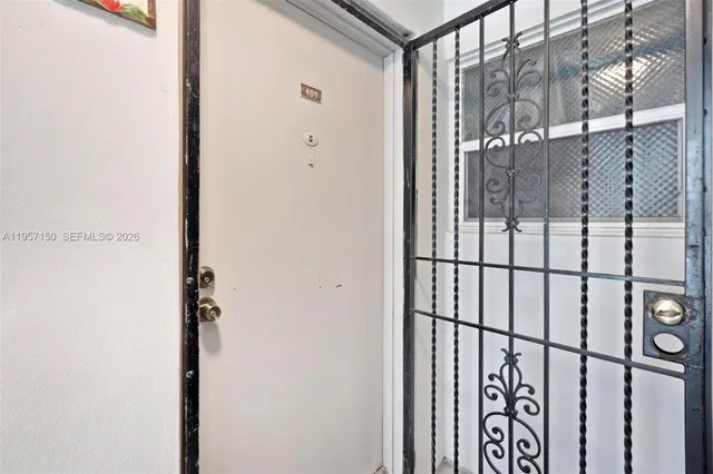 a kitchen with a stove a refrigerator and a dining table with wooden floor