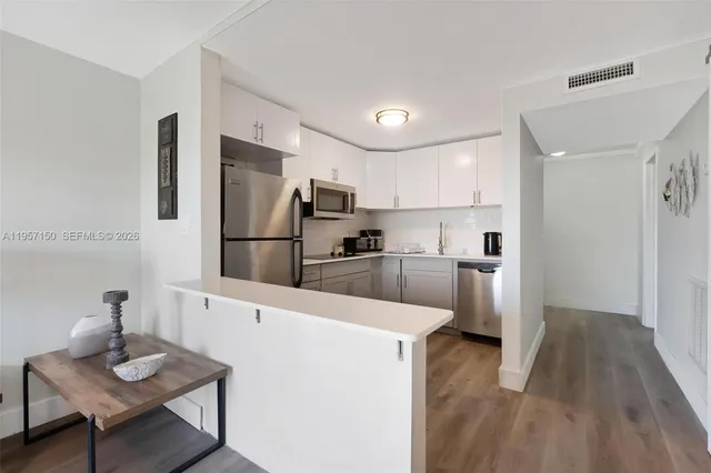 a kitchen with a refrigerator a sink and a stove