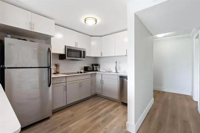 a kitchen with a refrigerator and a stove top oven