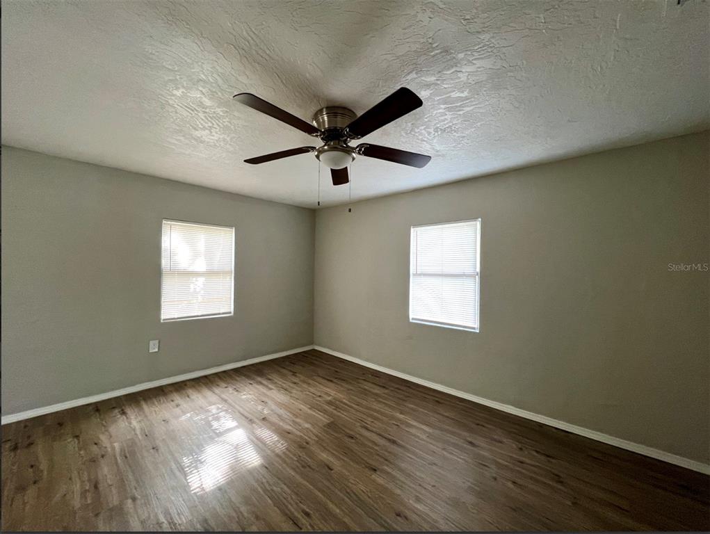 2003 10th Street South St. Petersburg, FL 33705 - Photo 6 of 16 an empty room with wooden floor and windows