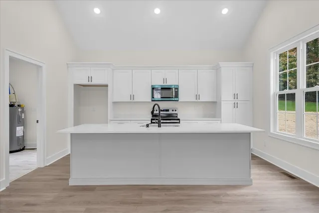 a kitchen with stainless steel appliances a refrigerator sink and cabinets
