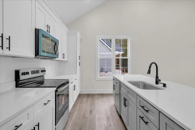 a kitchen with a sink and a refrigerator