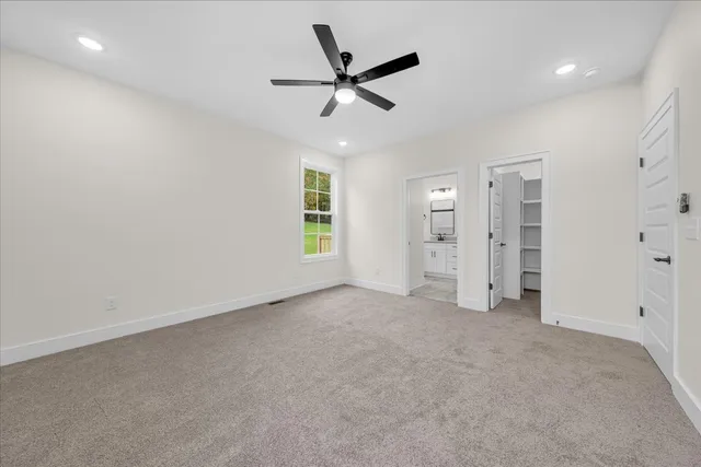 a bathroom with double vanity sink a mirror and a toilet