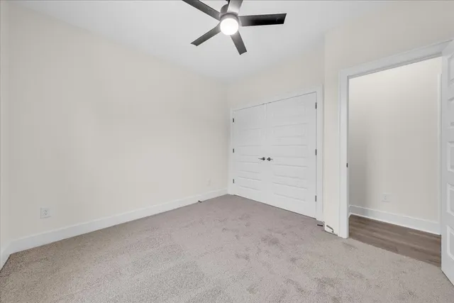a view of an empty room with a ceiling fan