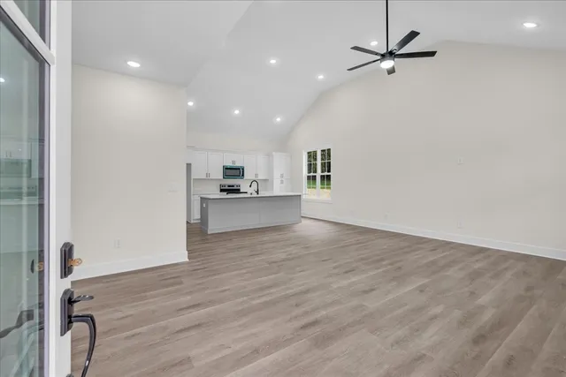 a view of a kitchen with a sink and a refrigerator