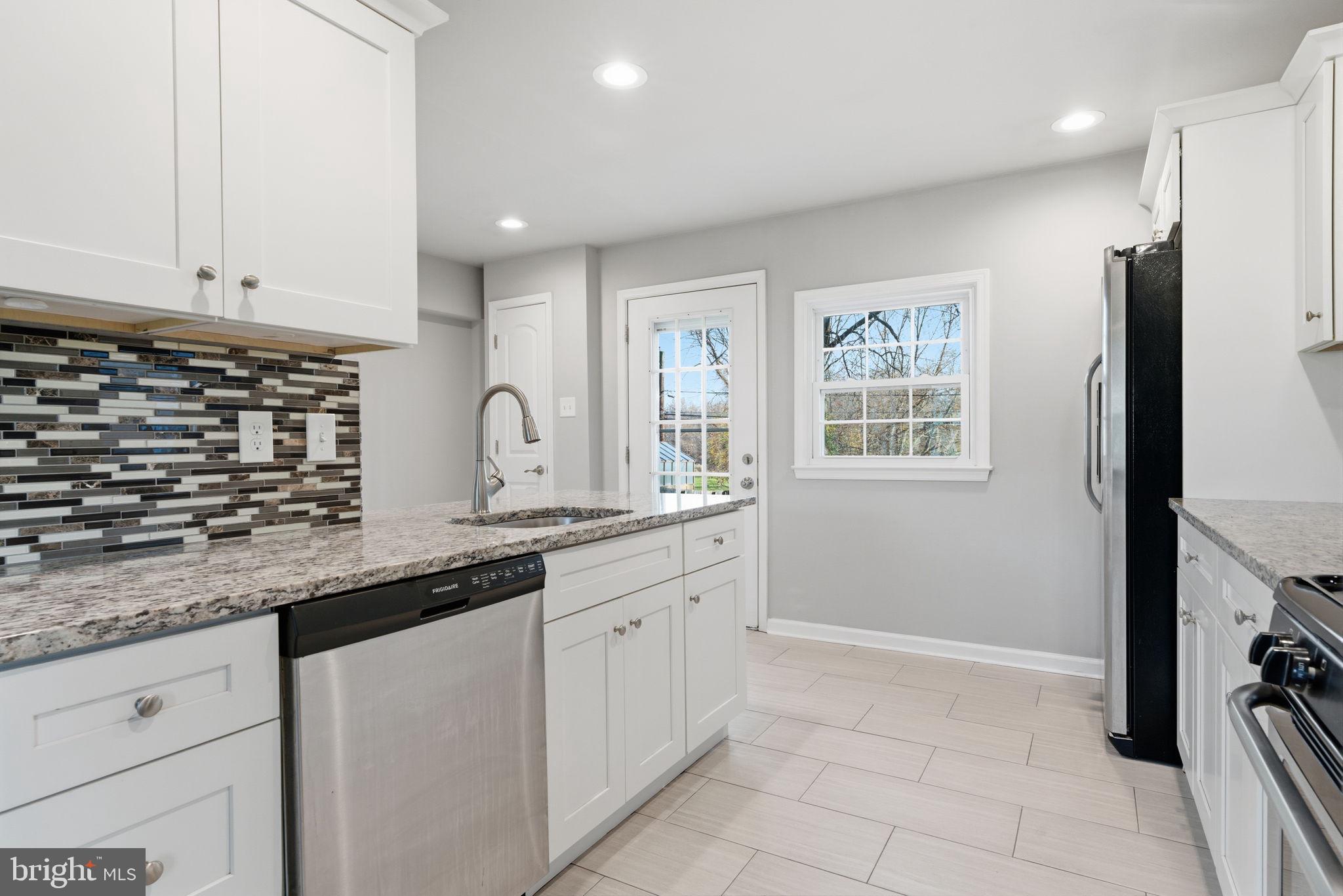 208 Trenton Road Fairless Hills, PA 19030 - Photo 12 of 35 a kitchen with granite countertop a sink stainless steel appliances and cabinets