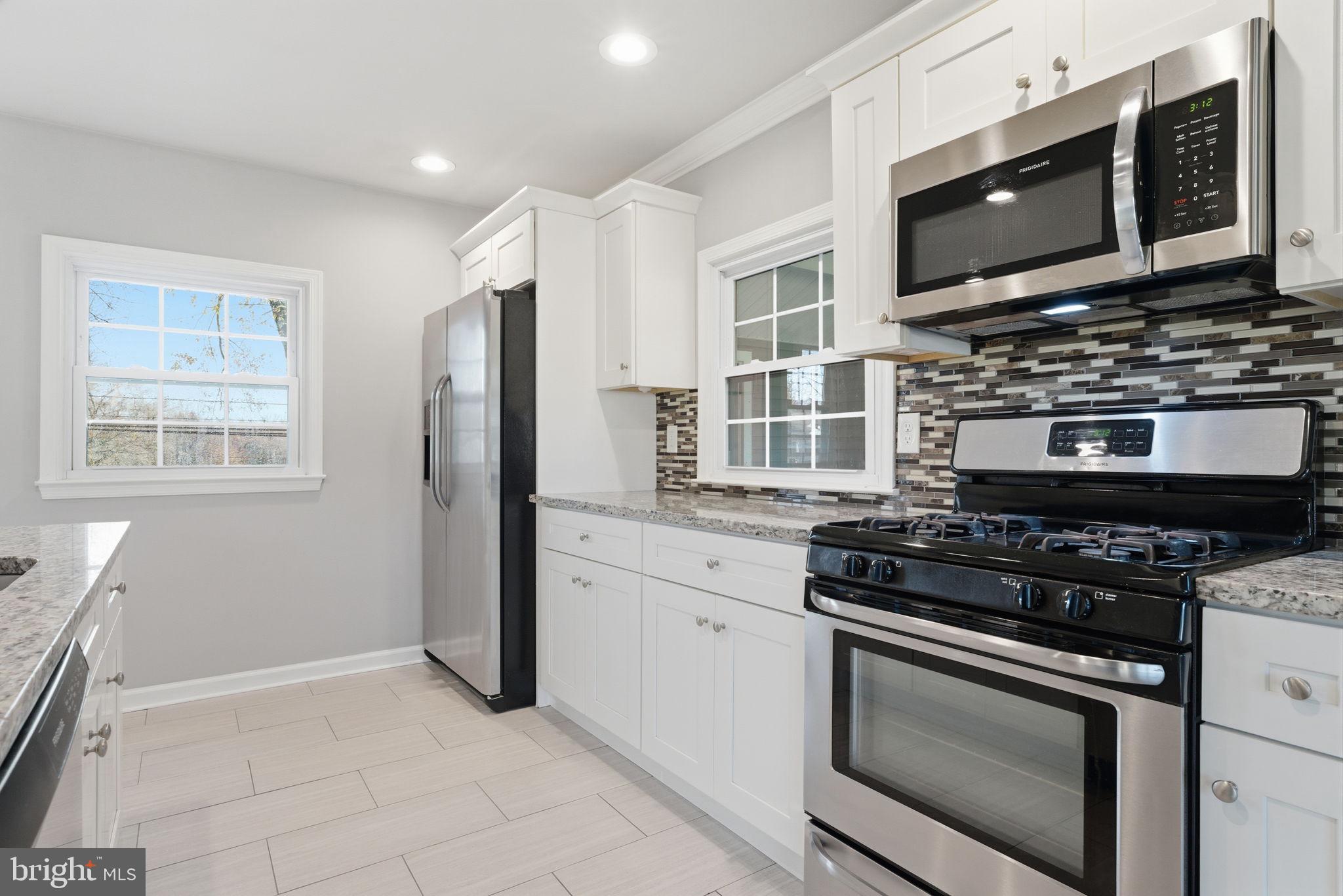 208 Trenton Road Fairless Hills, PA 19030 - Photo 13 of 35 a kitchen with stainless steel appliances a stove microwave and refrigerator