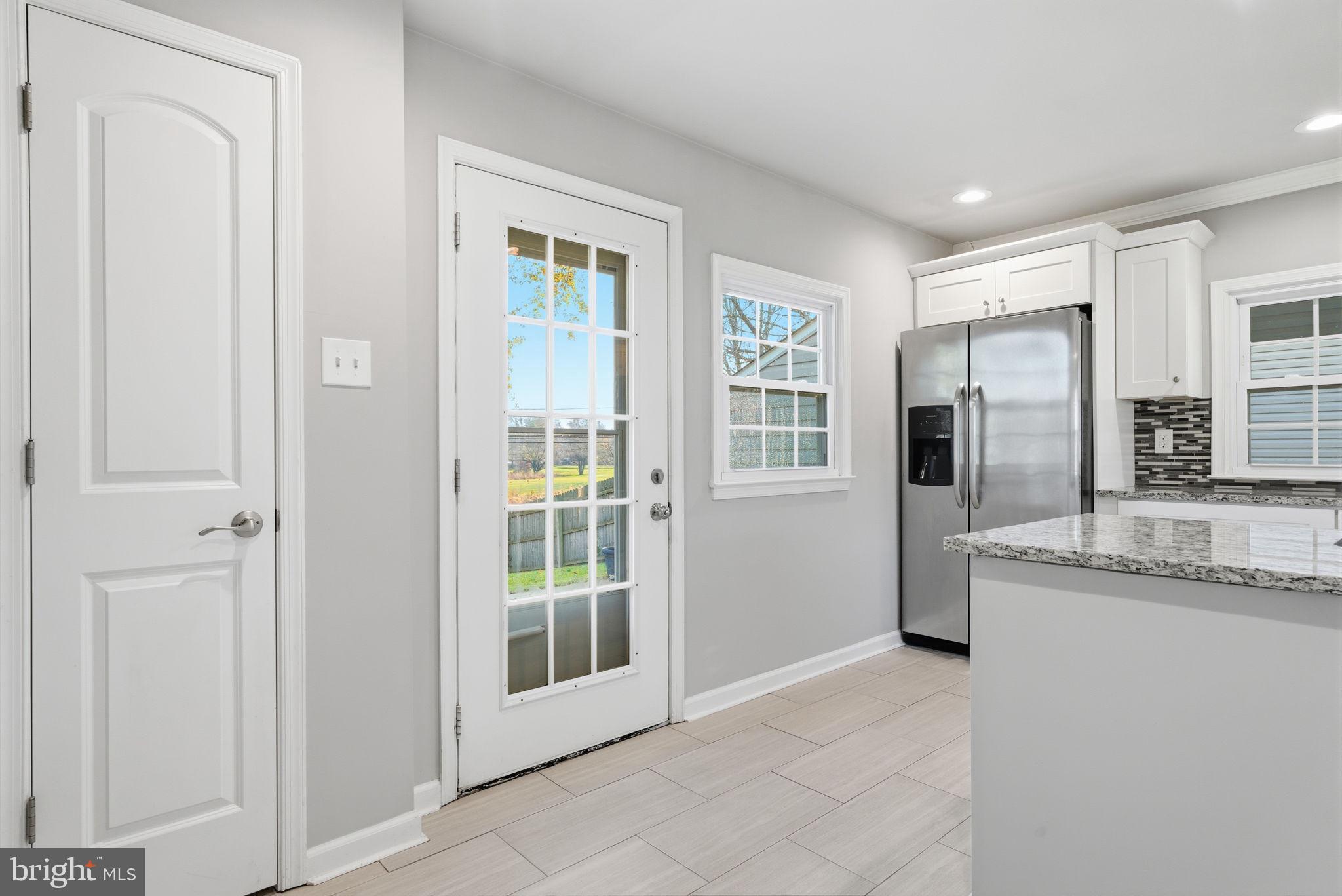 208 Trenton Road Fairless Hills, PA 19030 - Photo 16 of 35 a large white kitchen with granite countertop a refrigerator and a sink