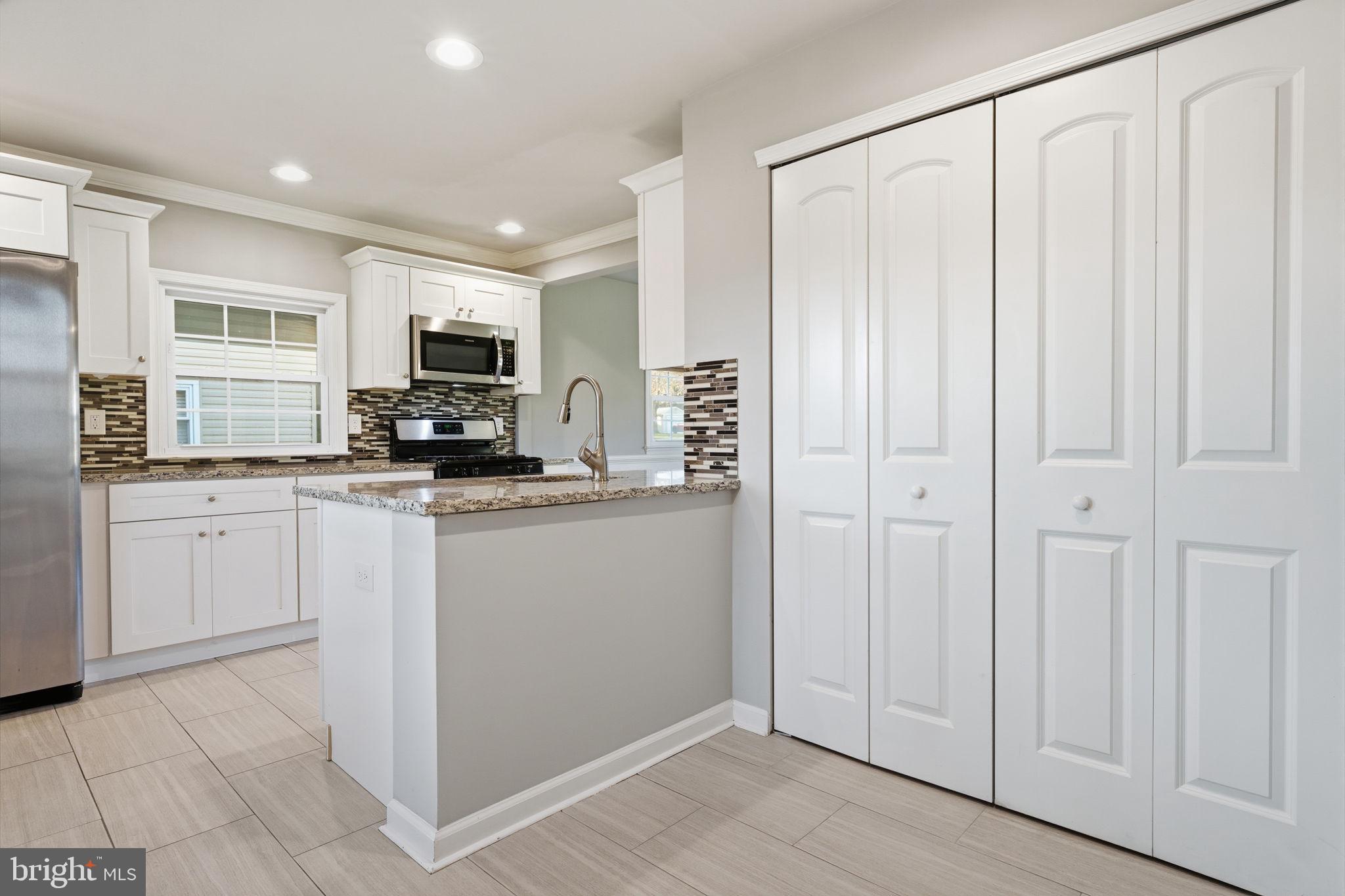 208 Trenton Road Fairless Hills, PA 19030 - Photo 17 of 35 a kitchen with white cabinets and white appliances