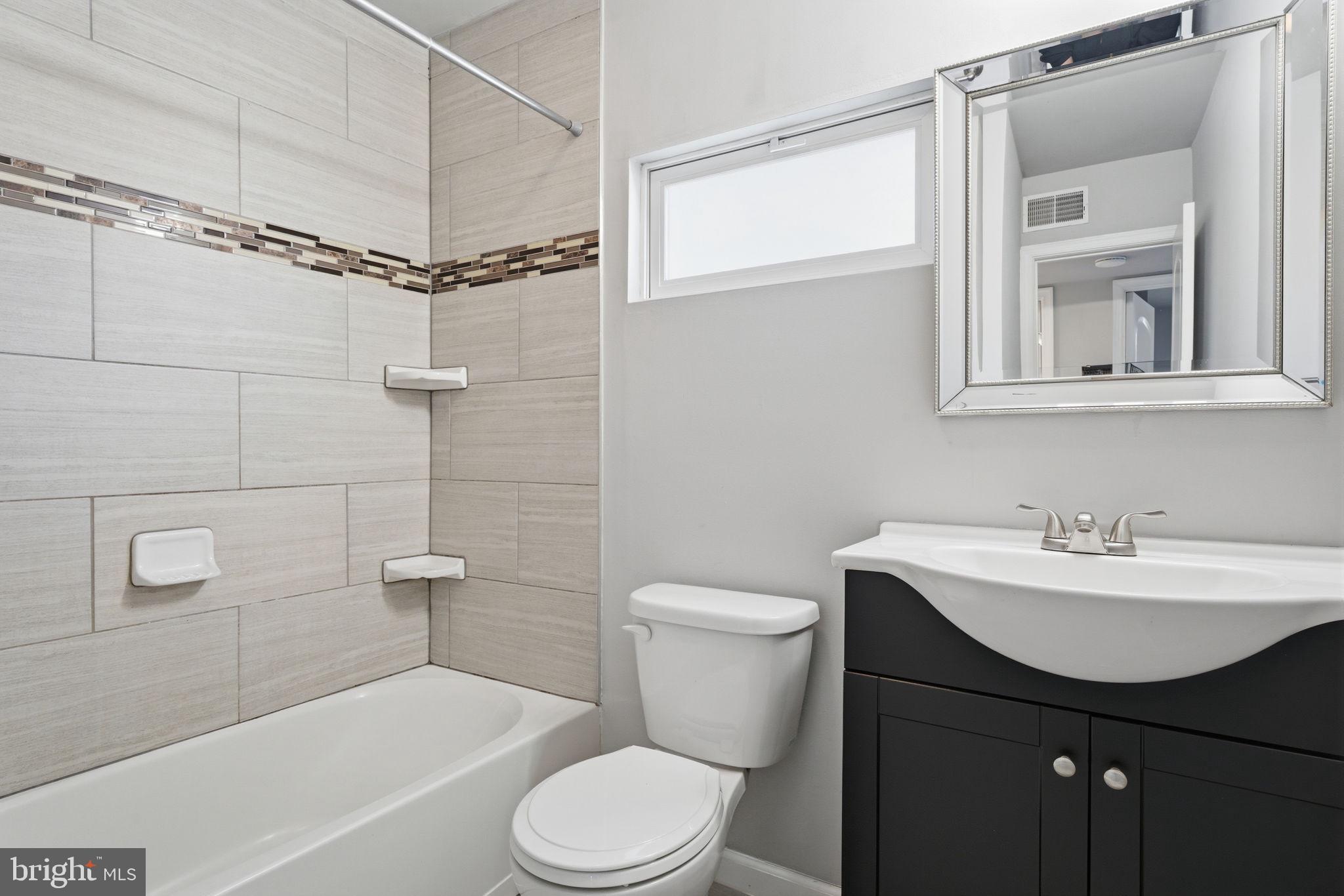208 Trenton Road Fairless Hills, PA 19030 - Photo 22 of 35 a bathroom with a sink a toilet and shower